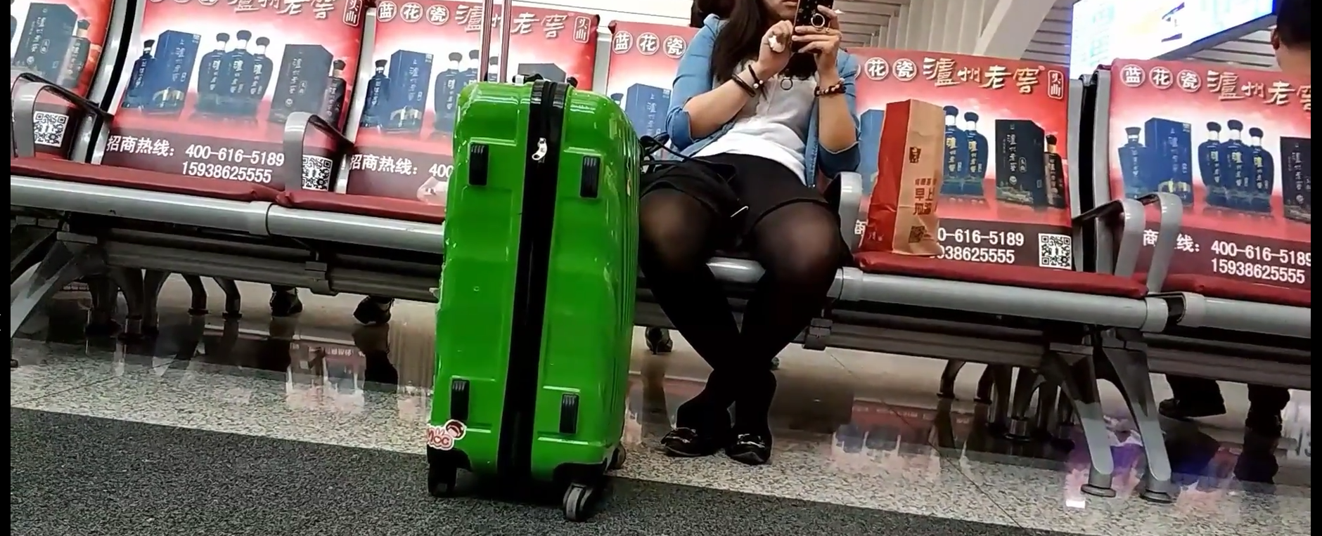 Lady great dangling shoeplay when waiting for the train in railway station lounge 6