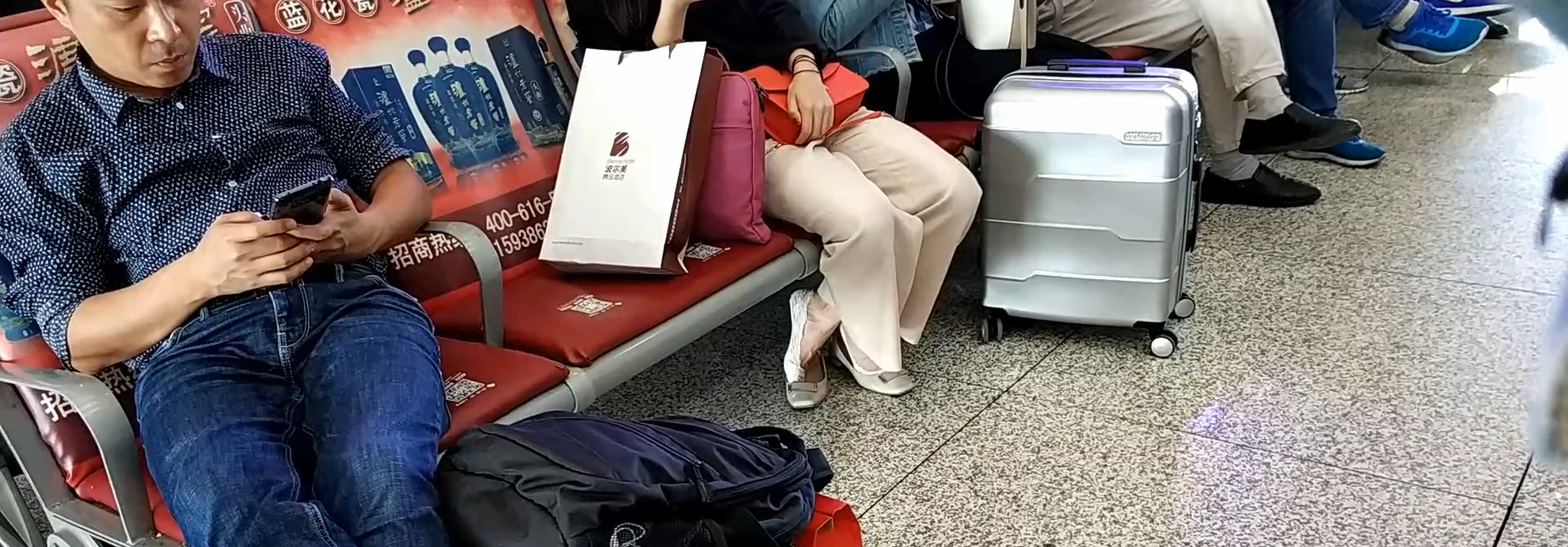 Lady great dangling shoeplay when waiting for the train in railway station lounge 8