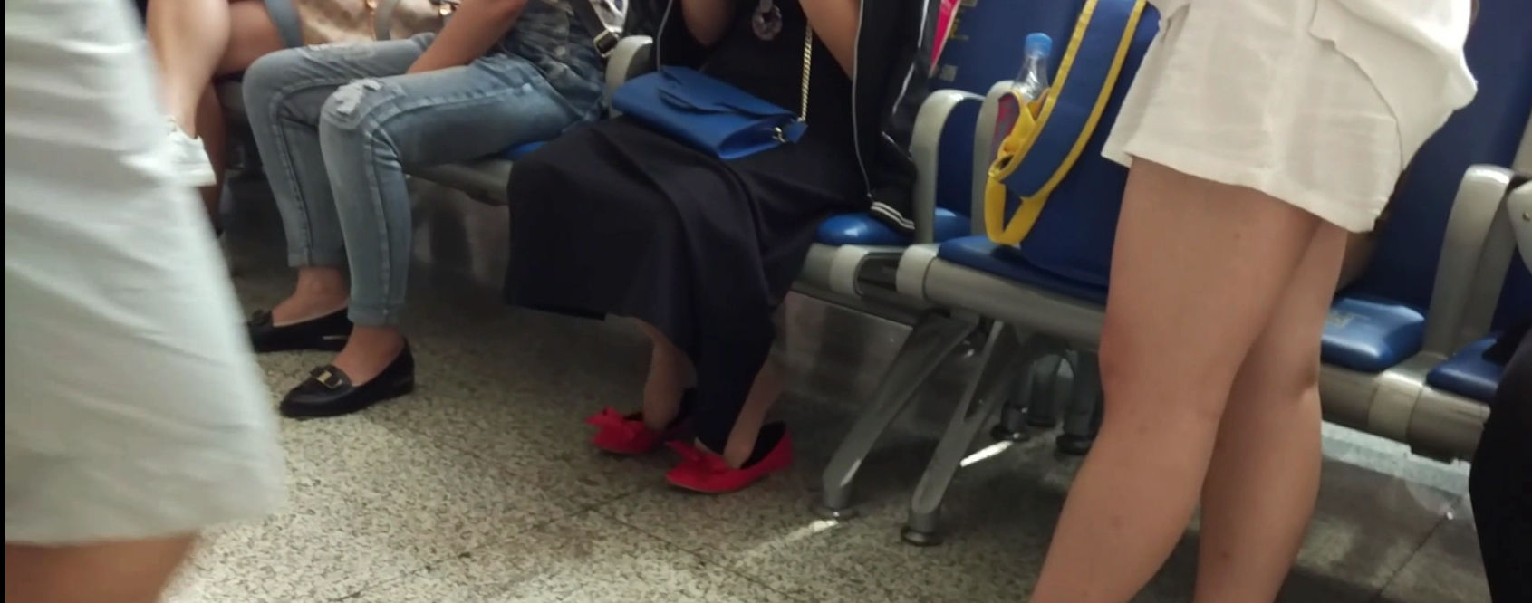 Lady great dangling shoeplay when waiting for the train in railway station lounge 18