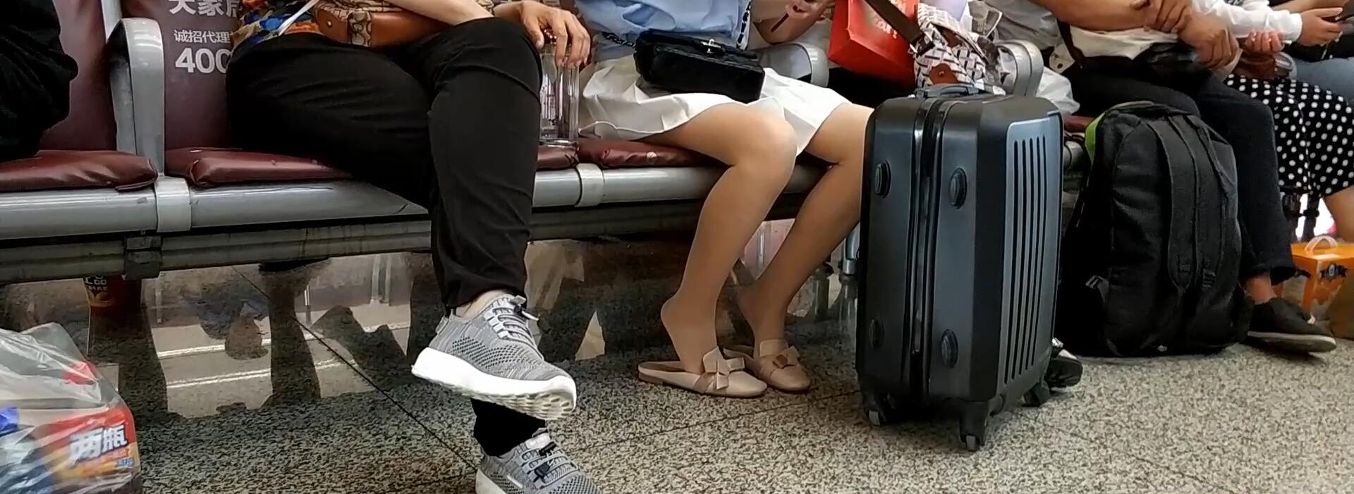 Lady dangling shoeplay when waiting for a train 40