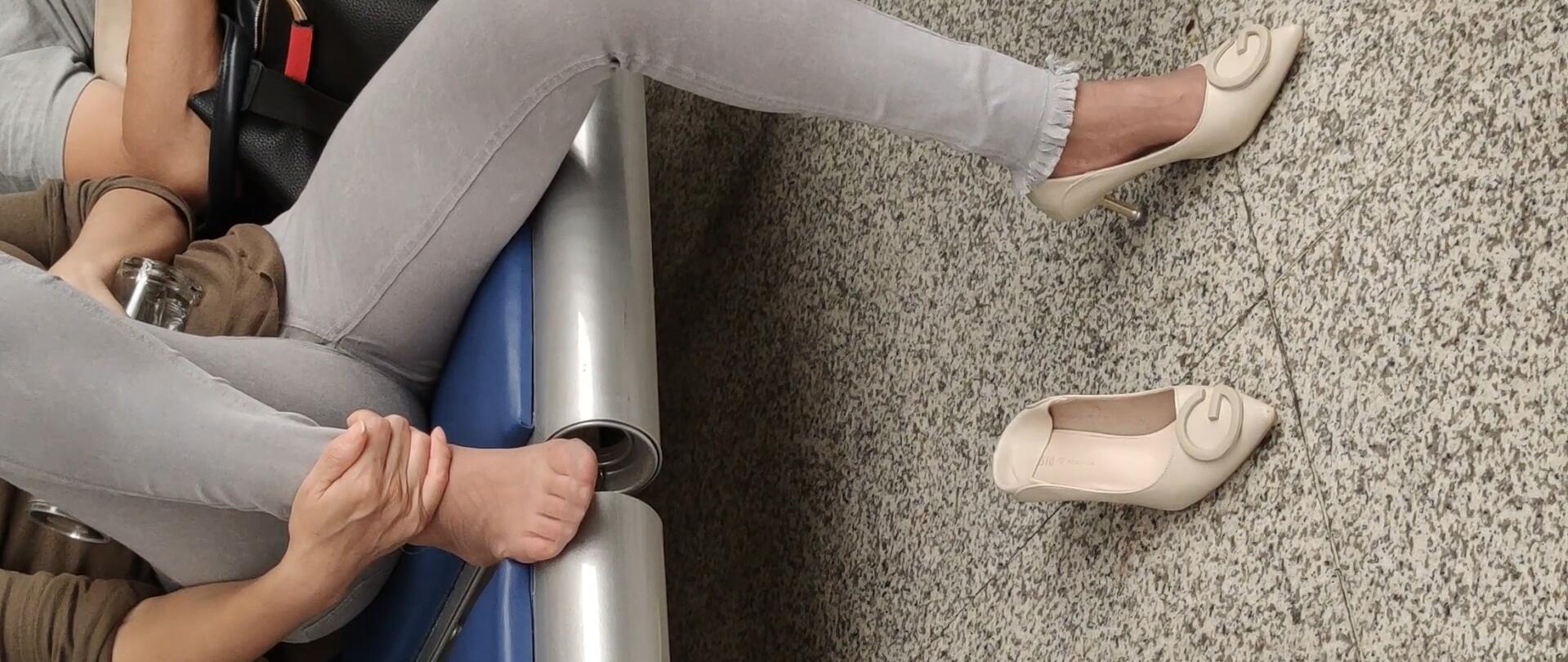 Lady dangling shoeplay when waiting for a train 51