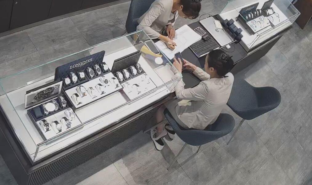 The jewelry store hostess in white dress and white heels sit down shoeplay