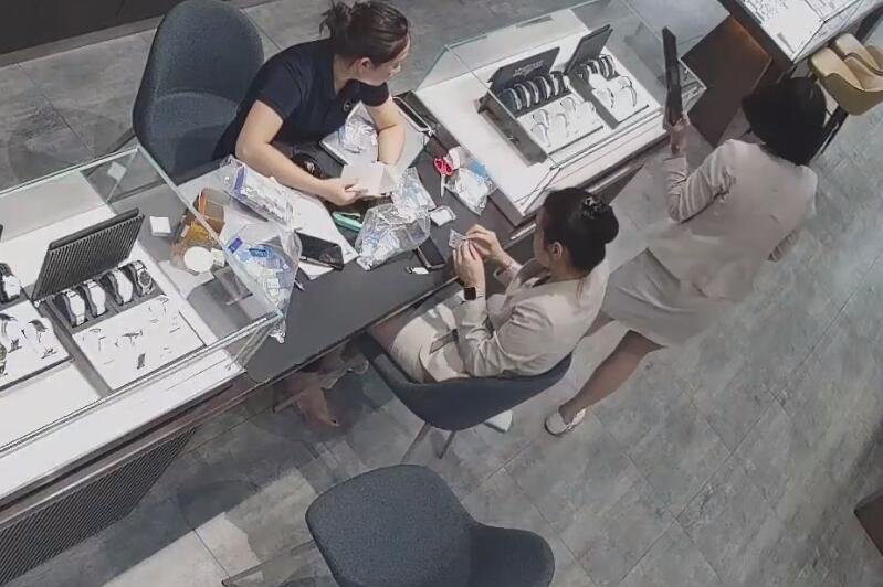 The jewelry store hostess in white dress and white heels sit down shoeplay 16