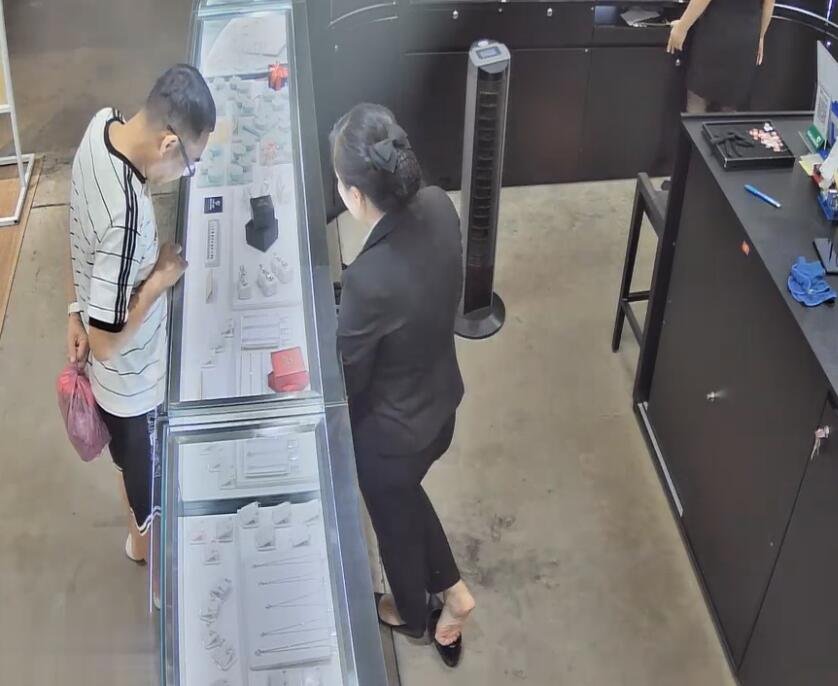 The jewelry store manager is not in black nylon